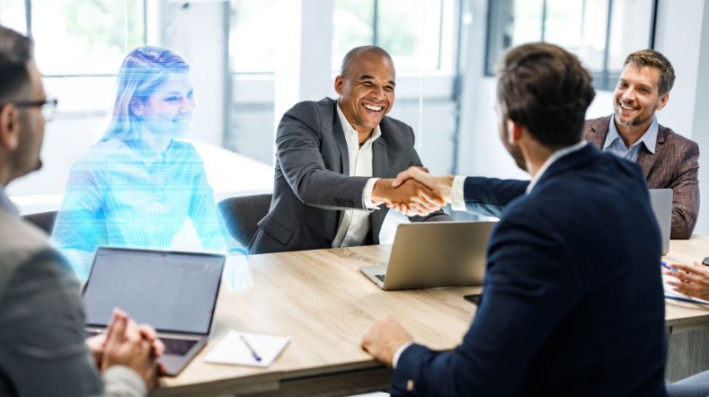 A work meeting in which one person attends the meeting in 3D